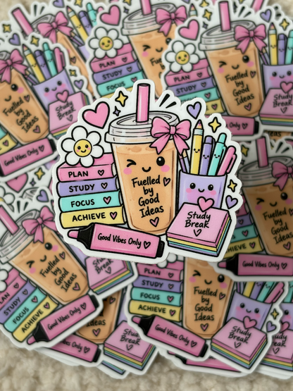 A pile of cute die-cut stickers featuring pastel-colored school supplies and motivational phrases, including books, pencils, a coffee cup, and flowers on a light beige textured background.