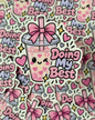 A die-cut sticker featuring a cute pink bubble tea cup with a smiling face, heart details, a pink bow, and the phrase 'Doing My Best' in pink and lavender lettering. The sticker is shown layered over a repeating pile of the same sticker design.