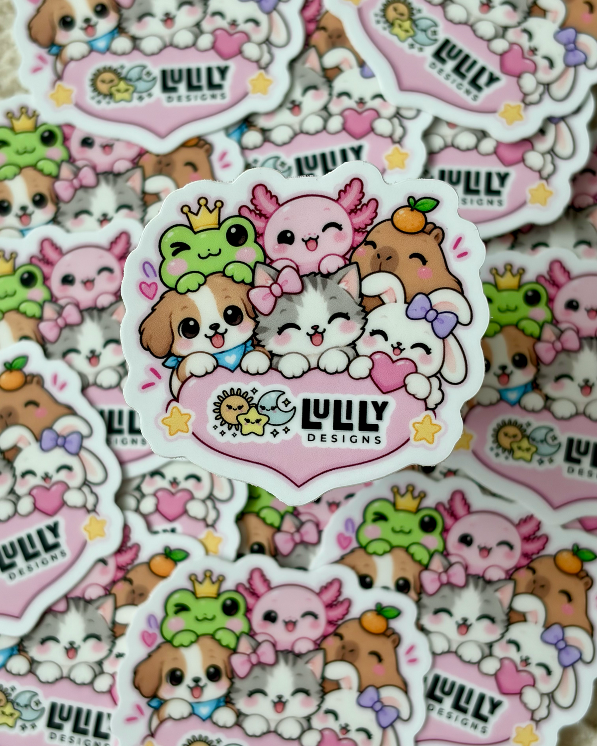 A close-up pile of cartoon animal stickers featuring cute dogs, cats, and frogs with hearts and the text 'LUZY DESIGNS' on a pink heart-shaped badge.