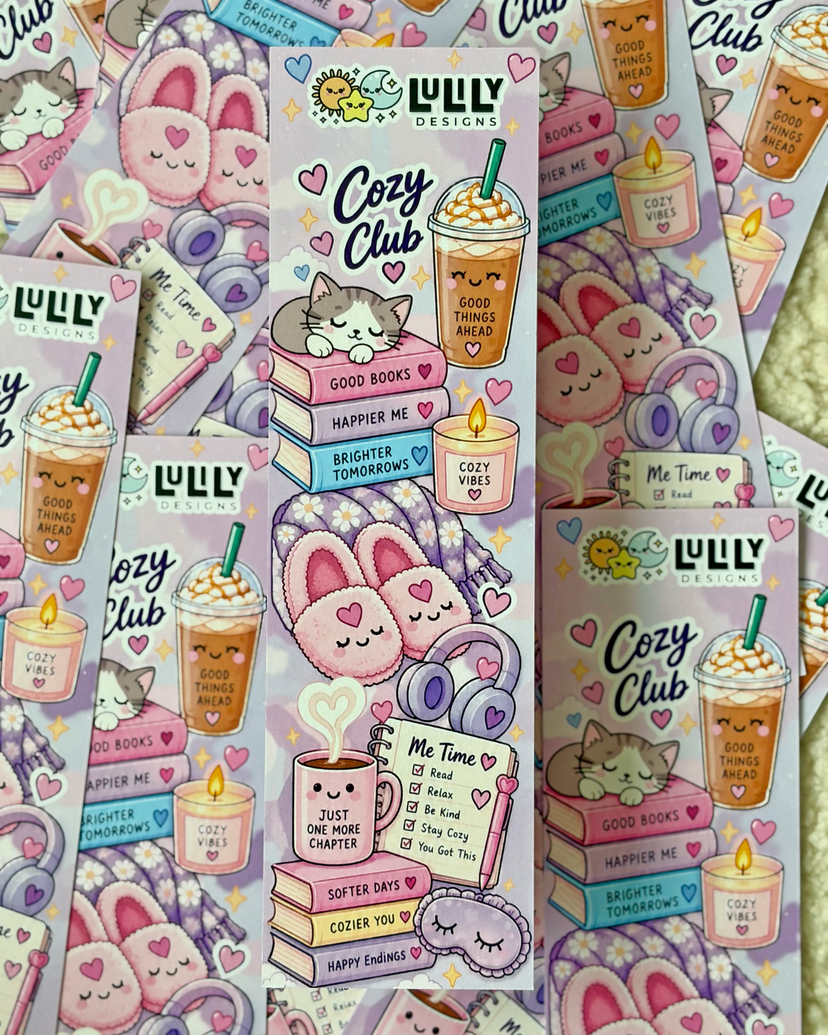 Several sheets of cute pastel sticker designs featuring a cozy bunny-themed aesthetic. The stickers include illustrations of a sleeping bunny on a stack of books, a coffee drink with a straw, candles, headphones, and hearts, with the text 'Cozy Club' and 'LULU DESIGNS'.