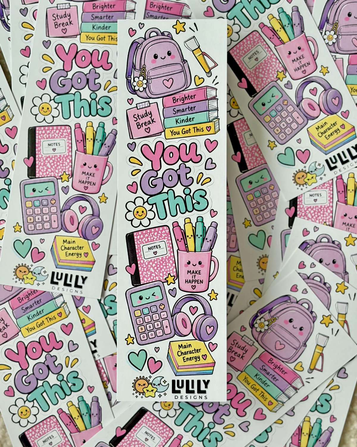 A sheet of cute school-themed stickers featuring the phrase 'You Got This' in colorful bubble letters, surrounded by illustrated backpacks, books, calculators, flowers, and motivational text. Multiple sheets are fanned out on a light beige textured surface.