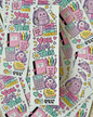 A sheet of cute school-themed stickers featuring the phrase 'You Got This' in colorful bubble letters, surrounded by illustrated backpacks, books, calculators, flowers, and motivational text. Multiple sheets are fanned out on a light beige textured surface.